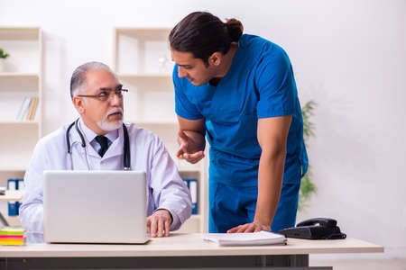 Two male doctors working in the clinicの写真素材