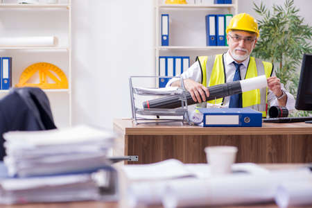Old male architect working in the officeの写真素材