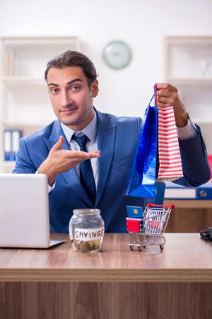 Young male businessman in ecommerce conceptの写真素材