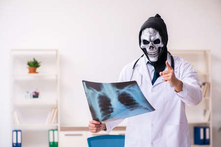 Male devil doctor radiologist working in the clinic