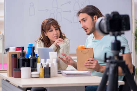 Young couple sales consultants recording video for their blog