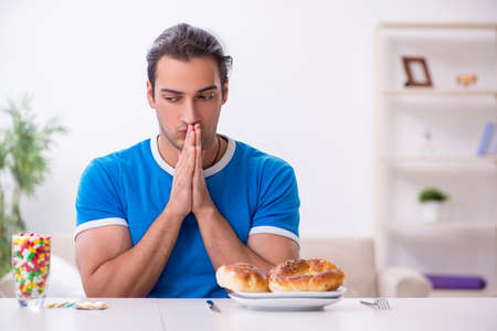 Young hungry man in dieting conceptの写真素材