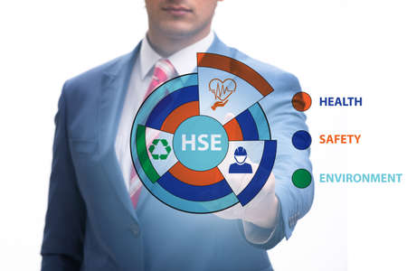 HSE concept with businessman pressing virtual buttonの写真素材