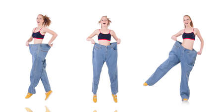 Woman with large jeans in dieting conceptの写真素材