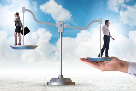 Work inequality concept with man and woman on scalesの写真素材