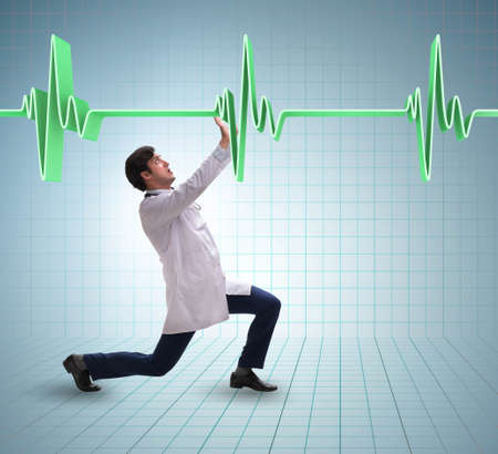 Doctor cardiologist supporting cardiogram heart lineの写真素材