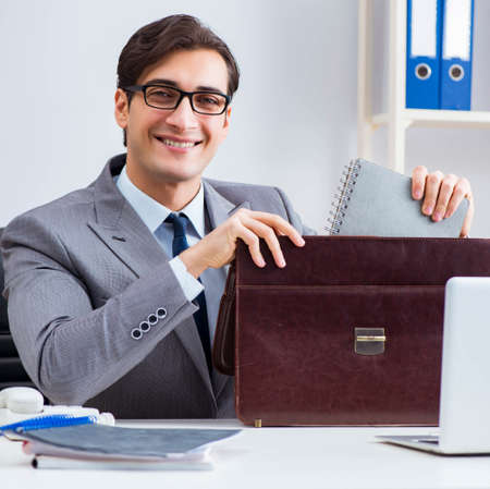 Young handsome businessman employee working in office at deskの写真素材