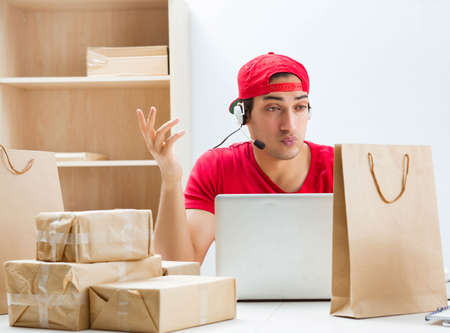 Call center worker at parcel distribution center in post officeの写真素材