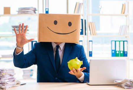 Happy man with box instead of his headの写真素材