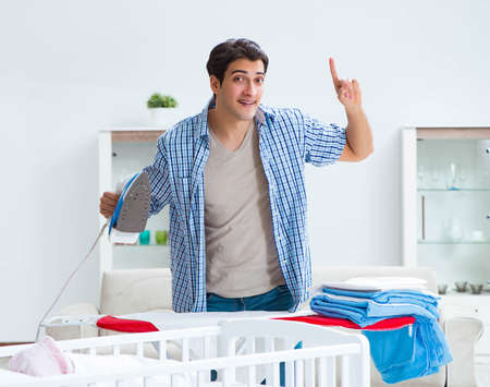 Young dad looking after newborn babyの写真素材