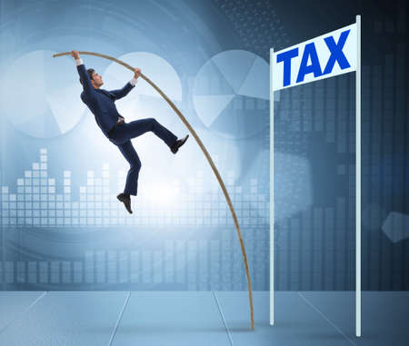 Businessman jumping over tax in tax evasion avoidance conceptの写真素材