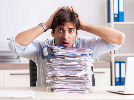 Overloaded busy employee with too much work and paperwork
