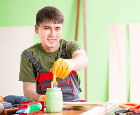 Young man carpenter working in workshopの写真素材