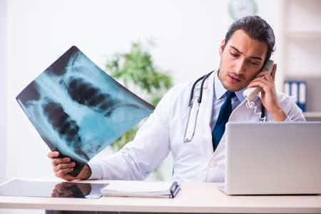 Young male handsome doctor working in the clinic