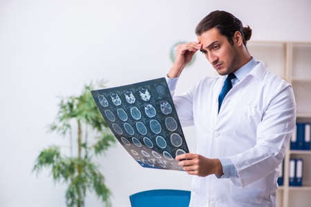 Young male handsome doctor working in the clinicの写真素材