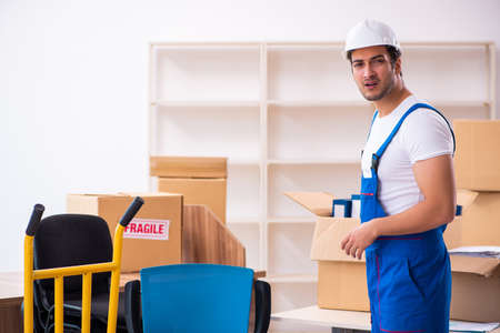 Young male professional mover doing home relocationの写真素材