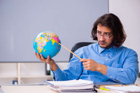 Young male teacher in the classroomの写真素材