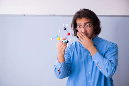 Young male teacher in the classroomの写真素材
