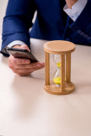 Young male employee in time management concept