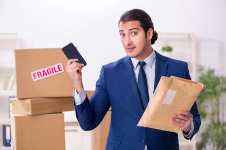 Young male logistics specialist working in the officeの写真素材