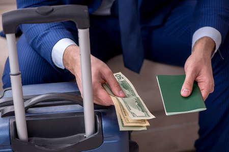 Young businessman holding passport preparing for tripの写真素材