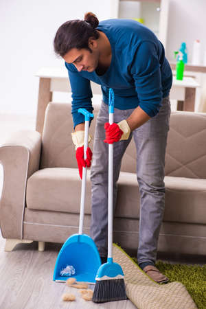 Young man husband doing housework at homeの写真素材