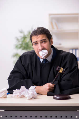 Young male judge working in courthouseの写真素材
