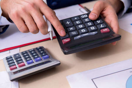 Young male financial manager in the office