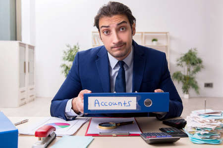 Young male financial manager in the office