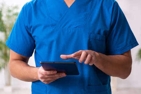 Young male doctor in telemedicine conceptの写真素材