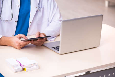 Young male doctor in telemedicine concept