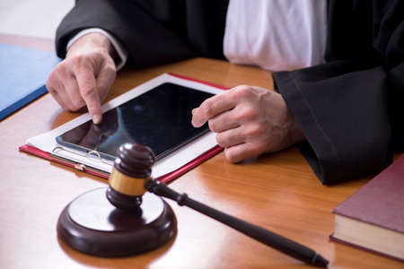 Old male judge working in courthouse