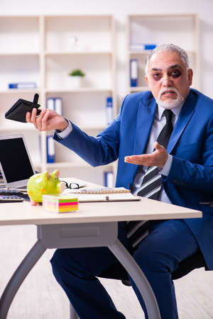 Old face injured employee sitting in the officeの写真素材