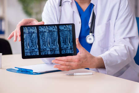 Old male doctor radiologist in telehealth concept