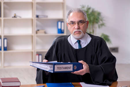 Old male judge working in courthouseの写真素材