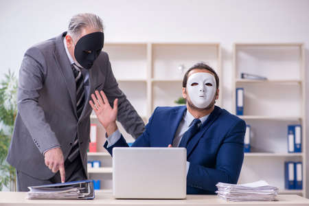 Old boss and young male employee wearing masksの写真素材