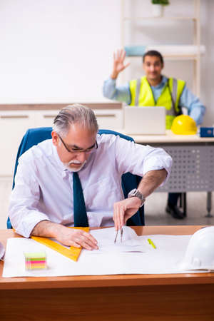 Two male architects working in the officeの写真素材