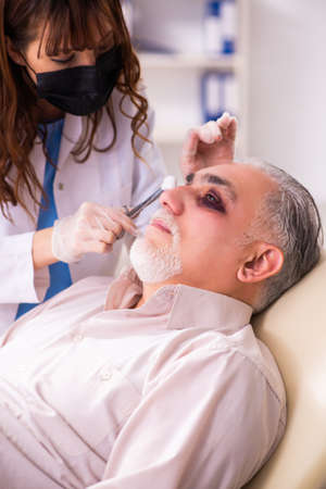 Old man visiting young female doctor for plastic surgery