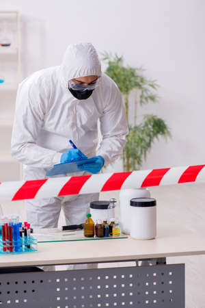 Young male chemist working in medicine labの写真素材