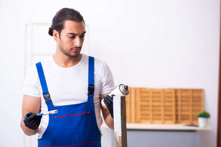 Young male contractor working in workshopの写真素材