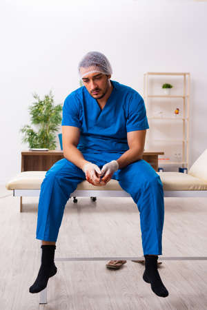 Young male doctor surgeon in fatal negligence conceptの写真素材