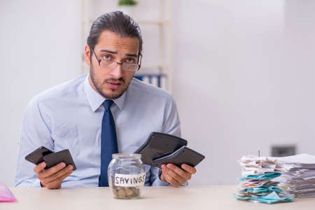 Young male employee in budget planning conceptの写真素材