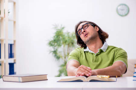Young male student preparing for exams at homeの写真素材