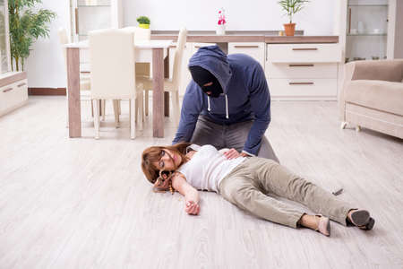 Gangster and young woman in robbery concept