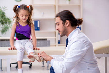 Small girl visiting young male doctorの写真素材