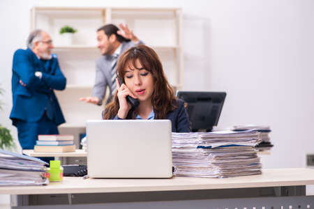 Two male and one female employees working in the officeの写真素材