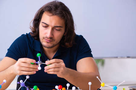 Young male scientist sitting in the classroomの写真素材