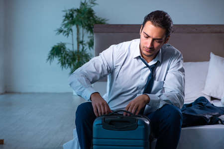 Young male employee in business trip conceptの写真素材