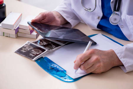 Old male doctor in telehealth concept
