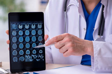 Old male doctor radiologist in telehealth concept